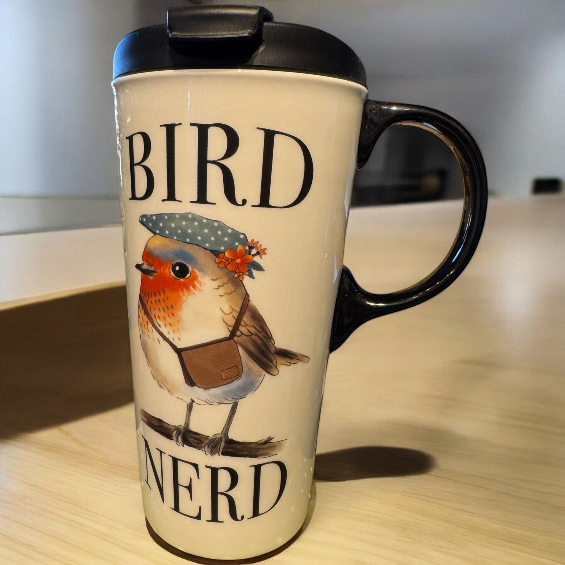 A coffee mug with a bird on it that says bird nerd