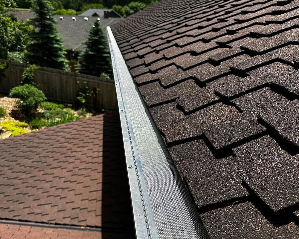 A close up of a gutter on the side of a roof.