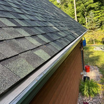 A close up of a roof with a gutter on it.