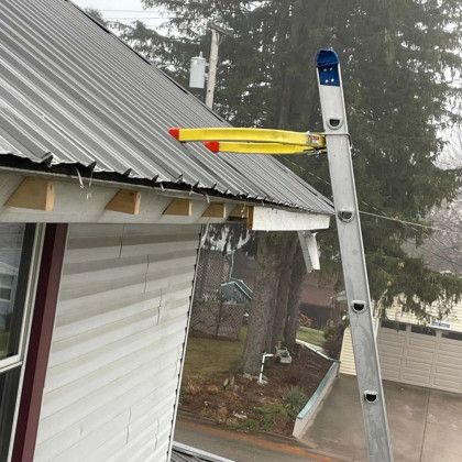 A ladder is attached to the side of a house.