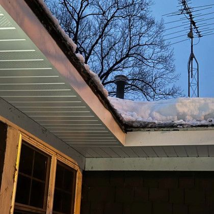 The roof of a house with snow on it