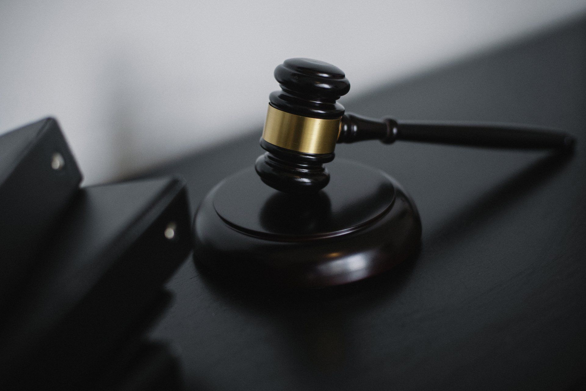 A judge 's gavel is sitting on  a black table, representing the topic of what to do after being served divorce papers.