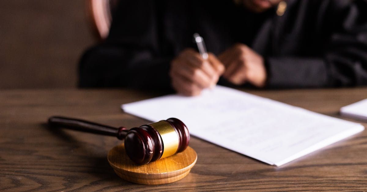 A judge is sitting at a table writing on a piece of paper.