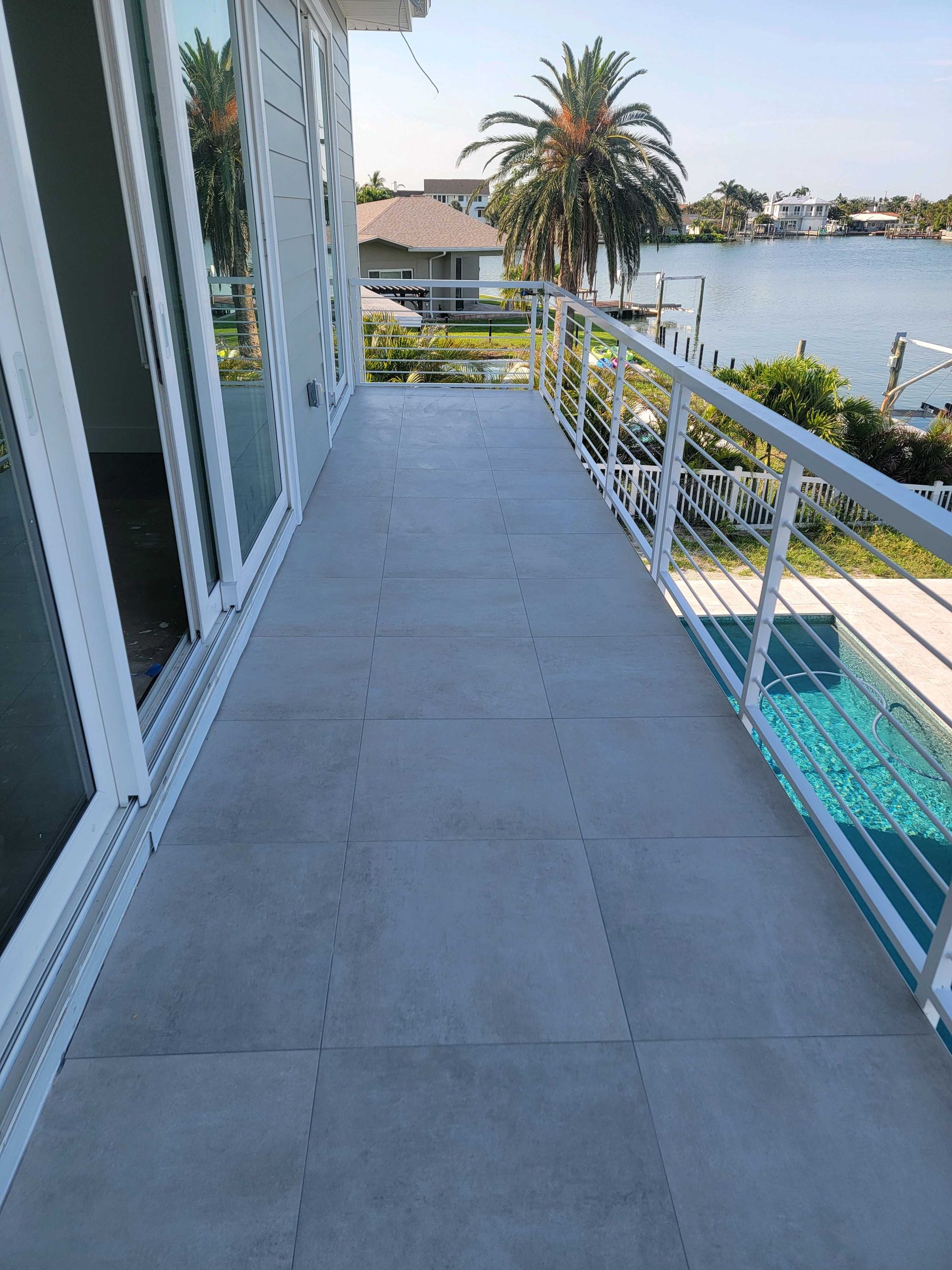 Blue scallop-shaped tile backsplash in a corner, with a light countertop and electrical outlet visible.