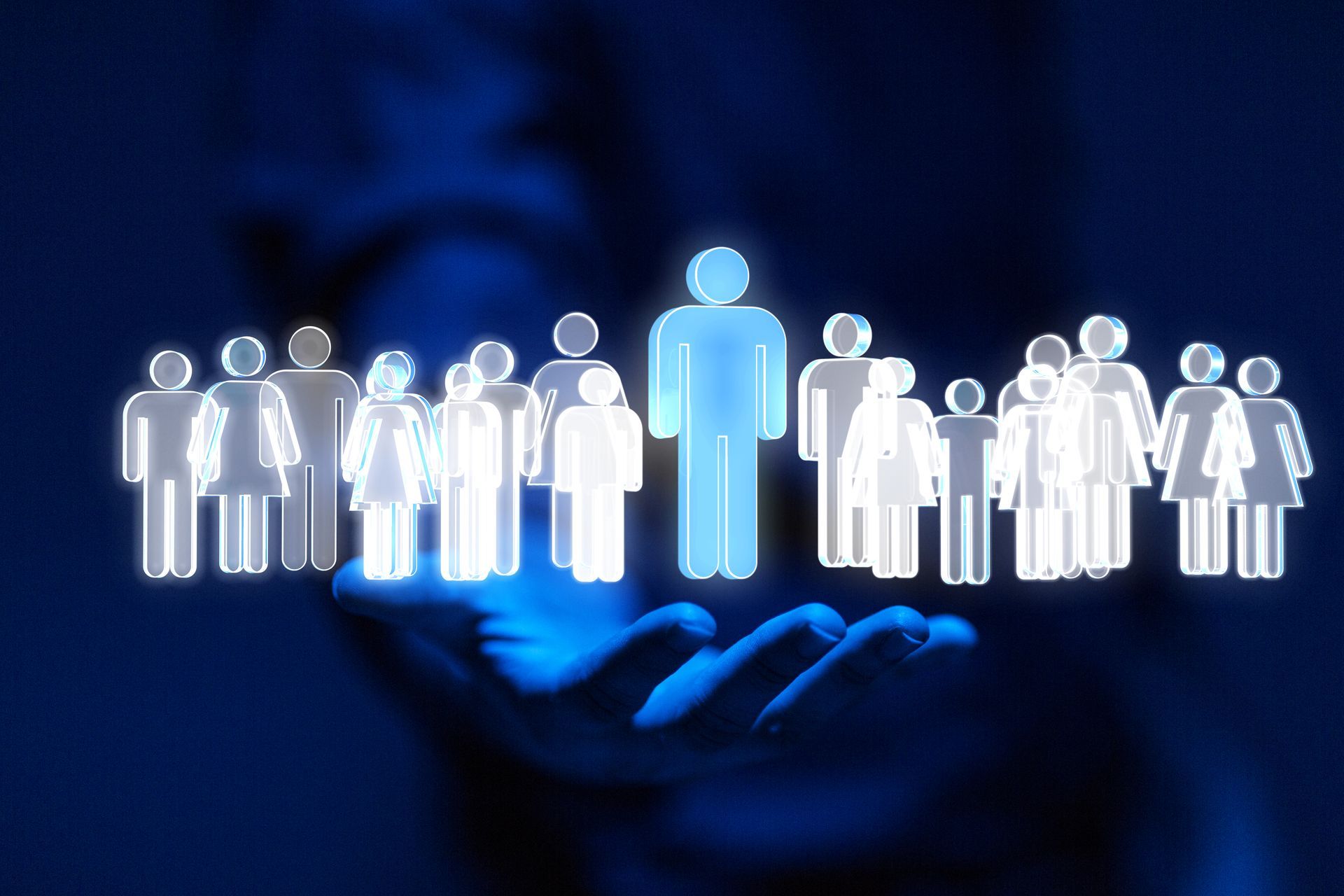 A person is holding a group of people in their hand