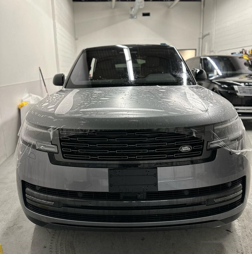 A range rover is parked in a garage.