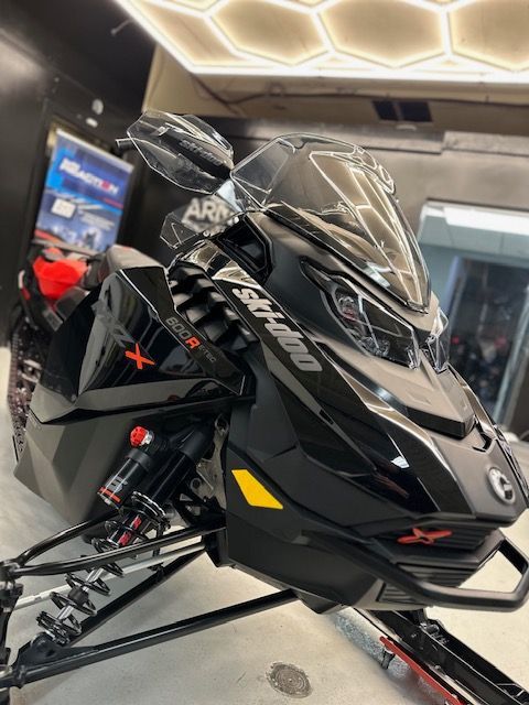 A man in a blue hat is working on a car