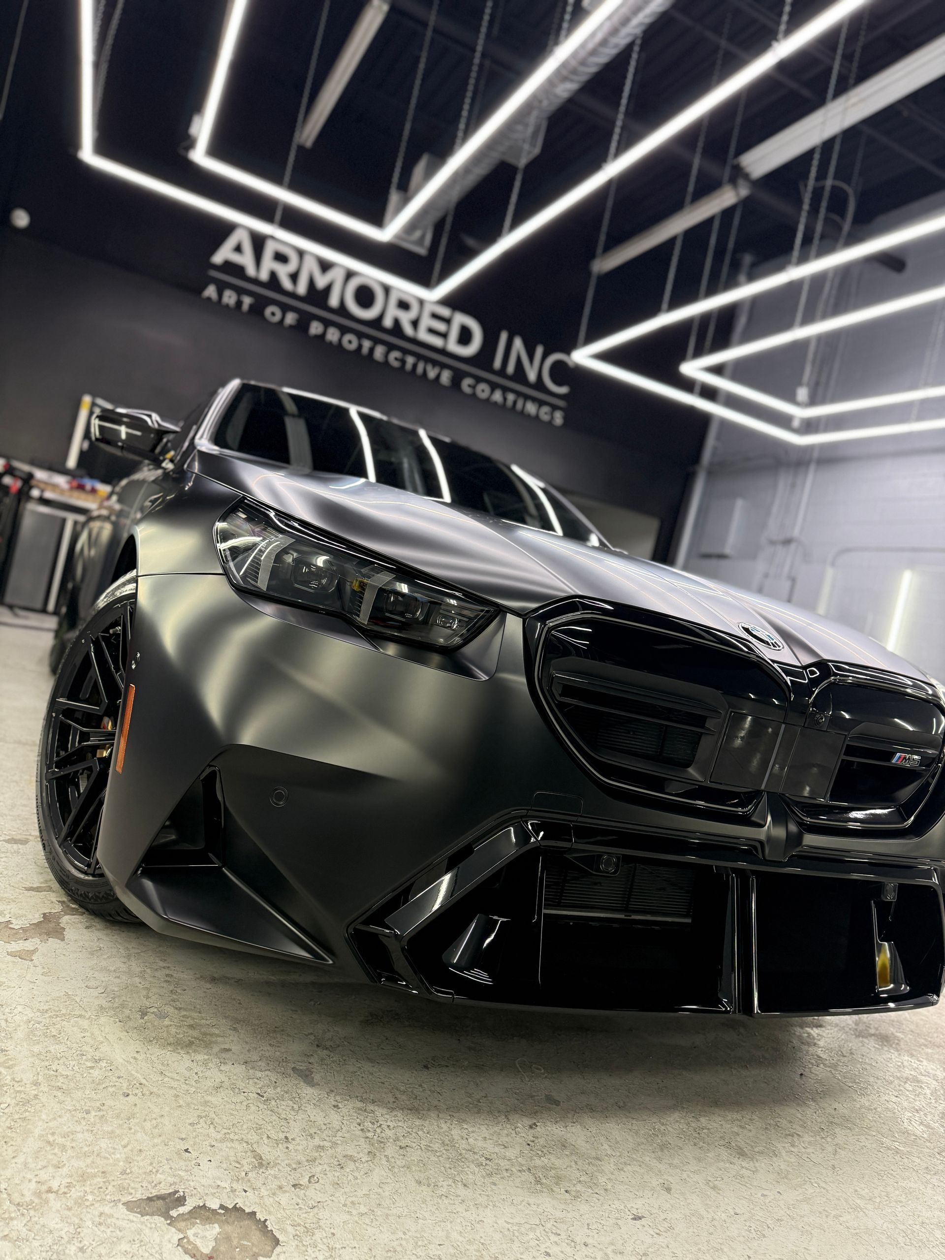 A black range rover is parked in a garage.