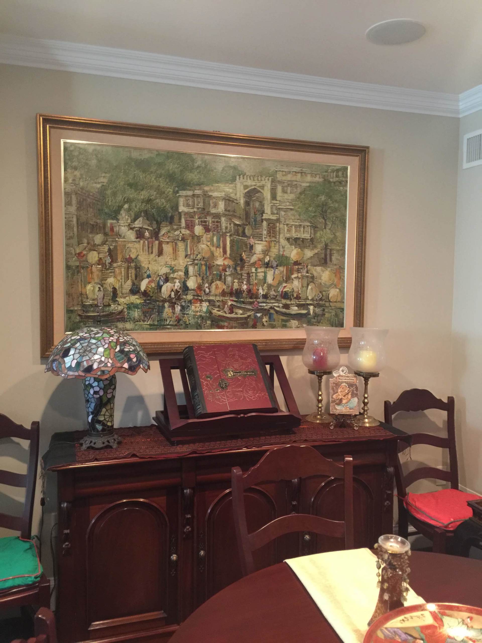 large landscape painting with an ancient wooden bookrest and candleholders by dismantle furniture