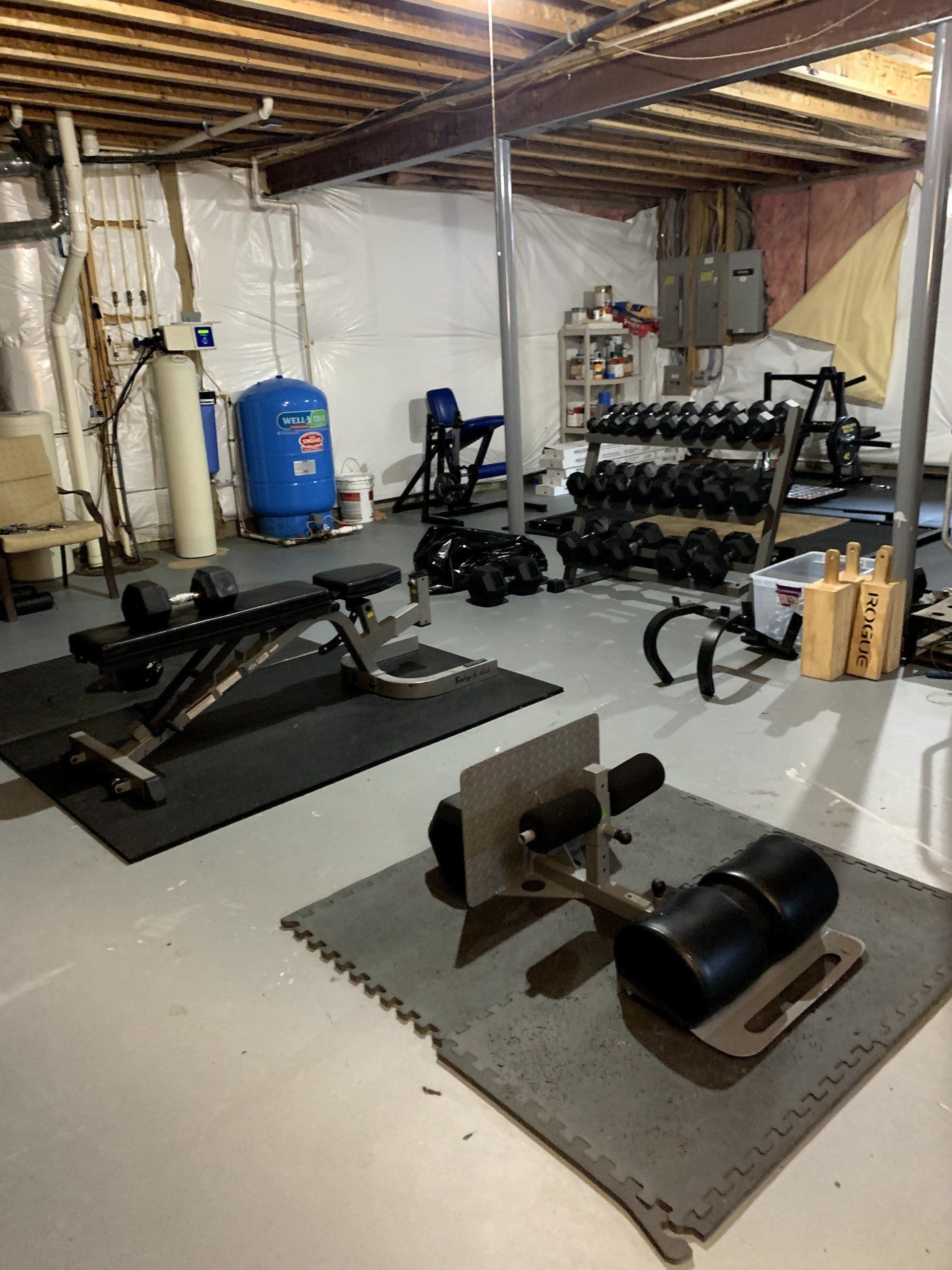 Home gym in a basement assembled by dismantle furniture