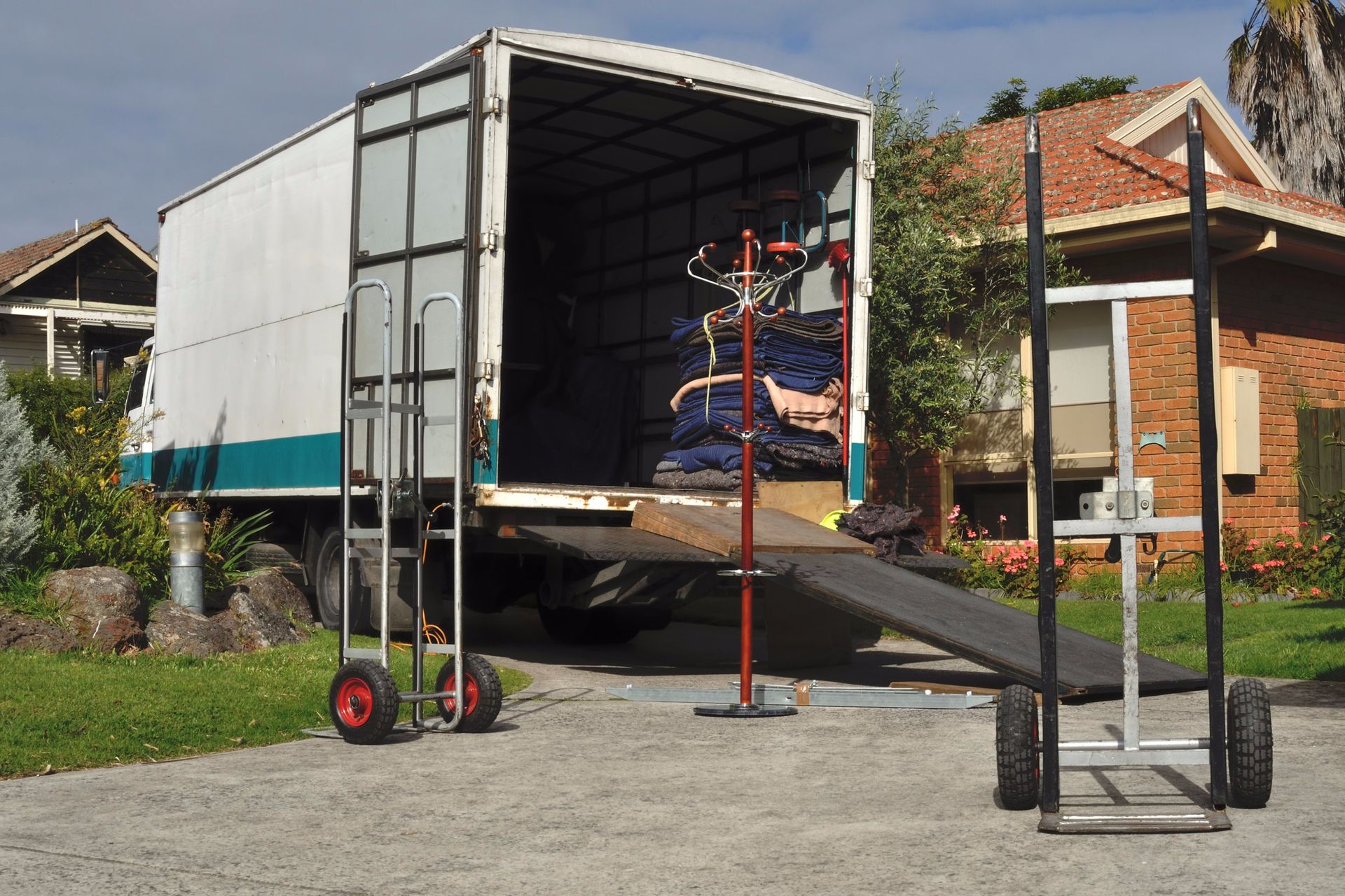 Moving truck loading household goods by movers team 