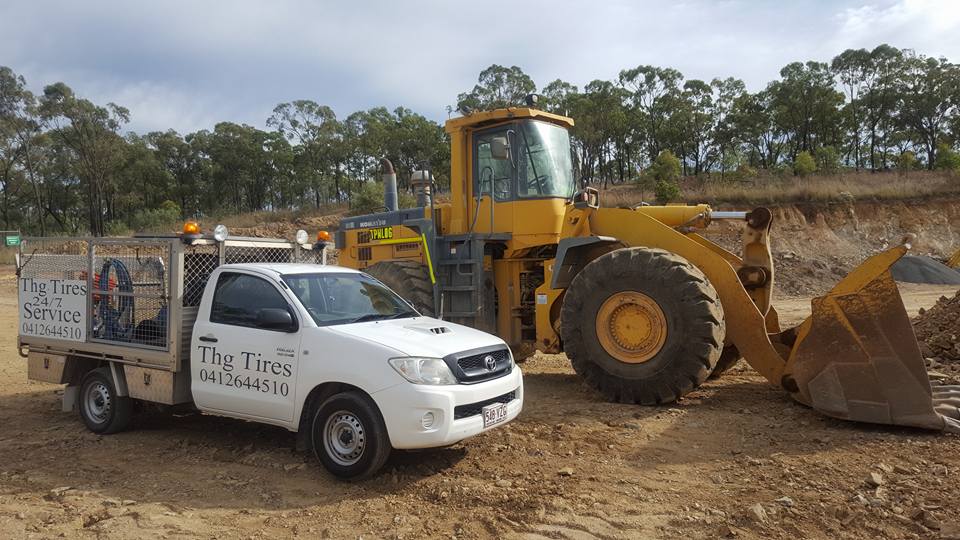 White Pick up Truck Beside Bulldozer — Reliable Agricultural Tyres in Gladstone, QLD