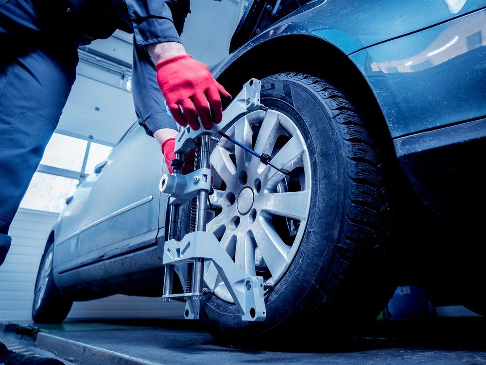 Car Mechanic Installing Sensor During Suspension Adjustment — Reliable Wheel Alignments in Gladstone, QLD