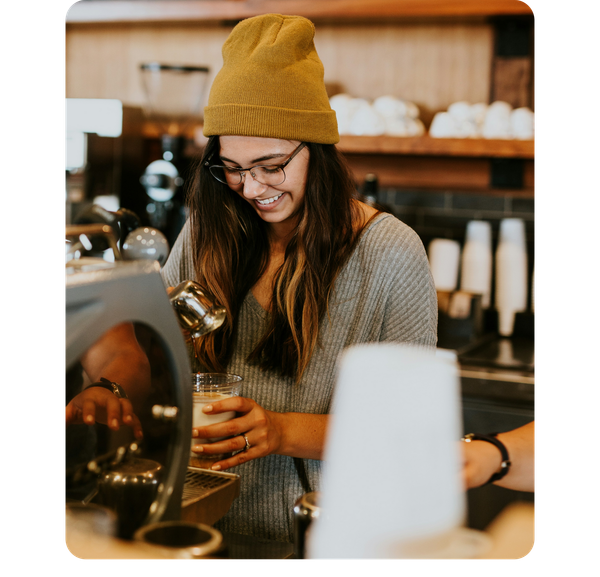 A woman is pouring coffee into a cup in a coffee shop. next to a google review.