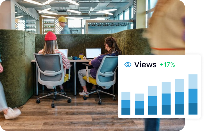 A group of people are sitting at desks in front of computers with a graphic showing the number of clics.