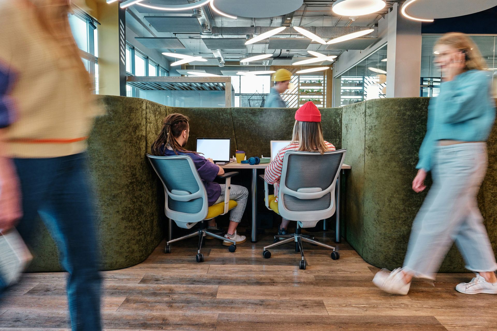 A group of people are sitting at desks in front of computers and a graphic showing the numbers of clics.