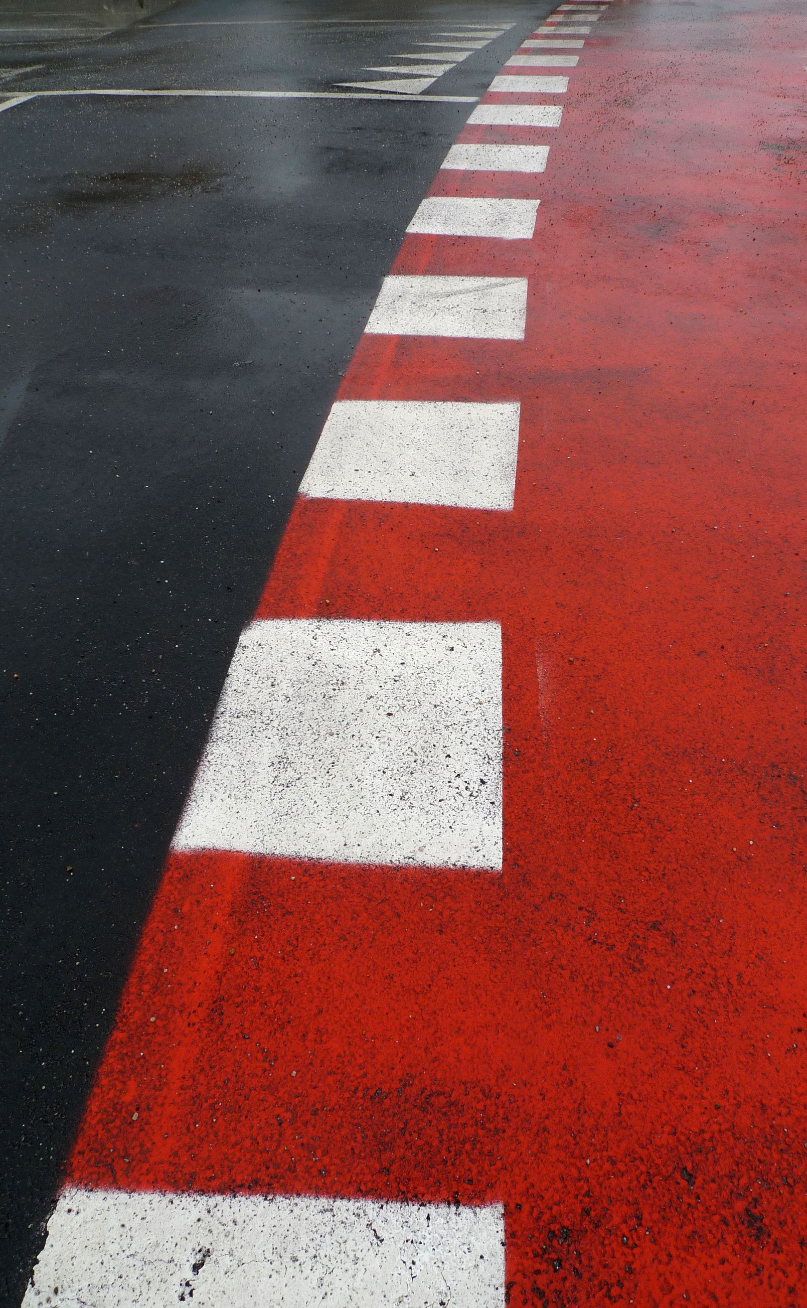 A red road with white stripes on it