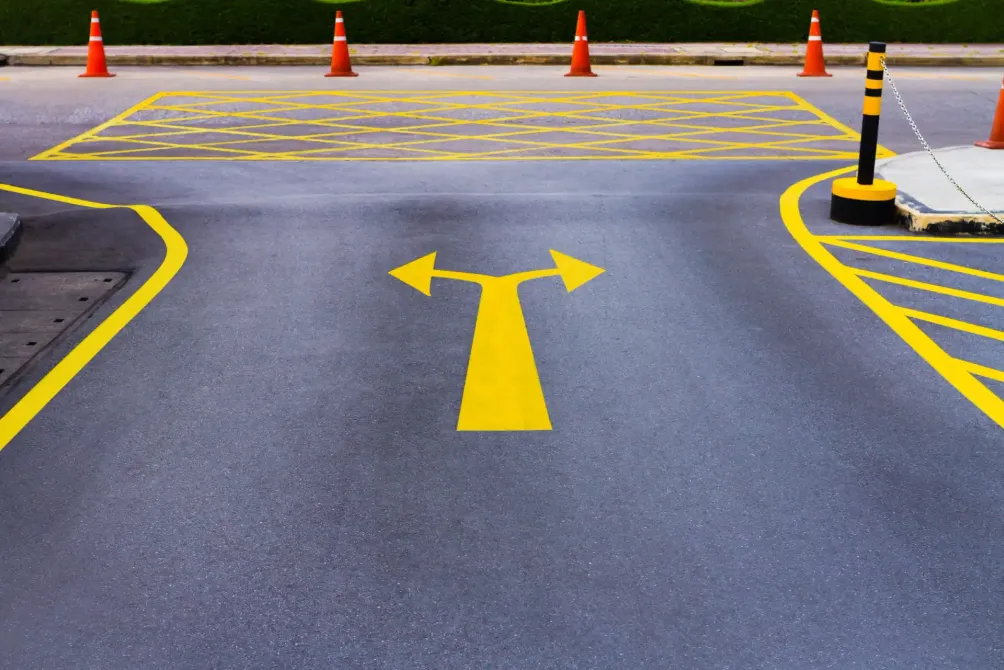 A road with a yellow arrow pointing in two directions