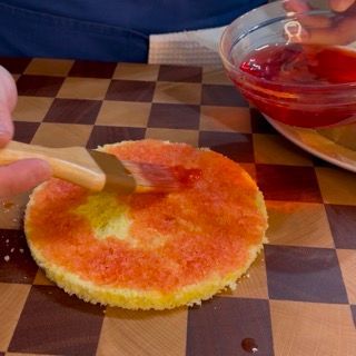 Una persona sta tagliando una fetta di torta su una scacchiera