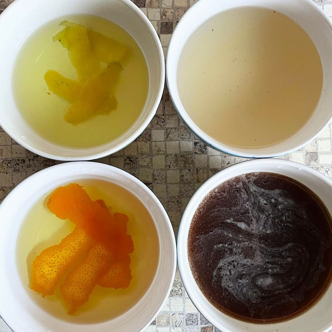 Quattro ciotole di liquidi di colore diverso sono su un tavolo