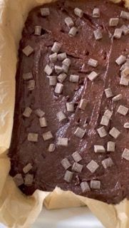 Un primo piano di un brownie con gocce di cioccolato sopra.