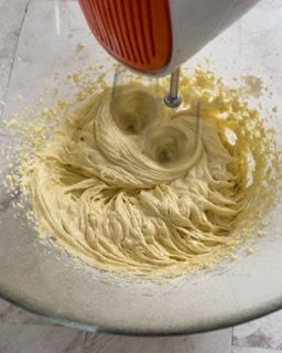 Un mixer sta mescolando qualcosa in una ciotola di vetro