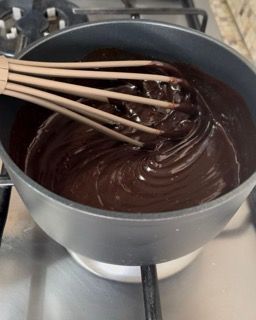 Una ciotola di salsa al cioccolato con una frusta dentro
