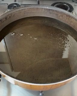 Una pentola piena d'acqua è posta sopra un fornello.