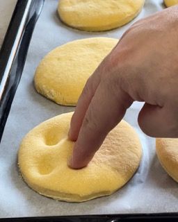 Una persona che preme il dito su un biscotto su un vassoio