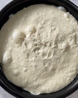 Primo piano di una ciotola di besciamella su un tavolo.