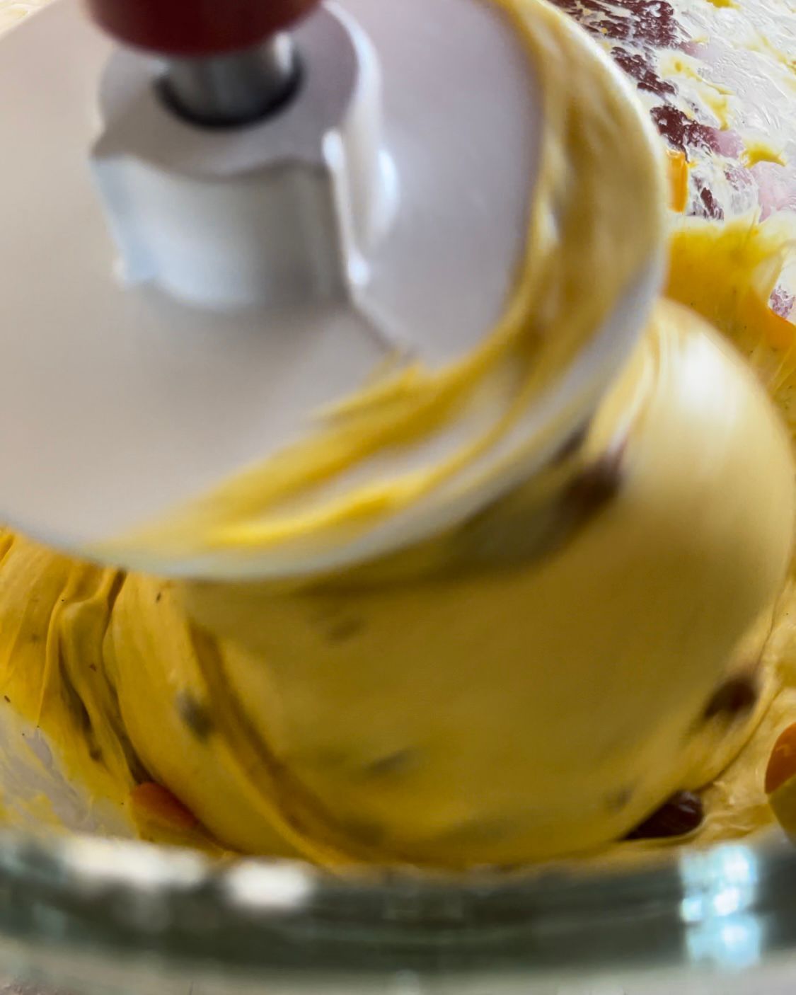 Primo piano di un frullatore pieno di liquido giallo.