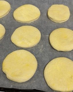 Un mucchio di cerchi di pasta su un pezzo di carta oleata