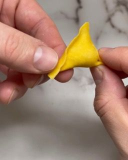 Una persona tiene in mano un fiore giallo.