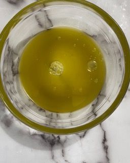 Ingredienti per la salamoia: olio EVO, acqua, pepe nero in un contenitore