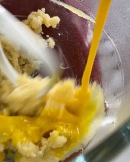 Un liquido giallo viene versato in una ciotola di cibo.