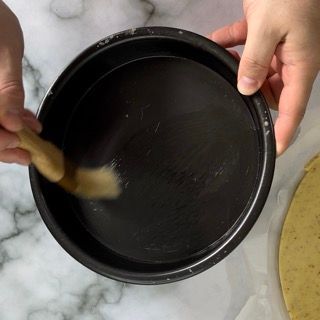 Una persona sta pulendo una padella con una spazzola