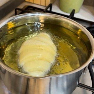 Un croissant viene cucinato in una pentola di olio