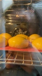 Un mazzo di limoni è appoggiato su una griglia nel forno.