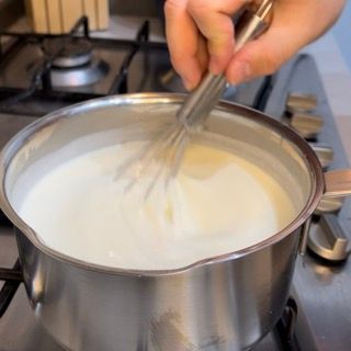 Composto di latte e roux liscio, riportato sul fuoco.