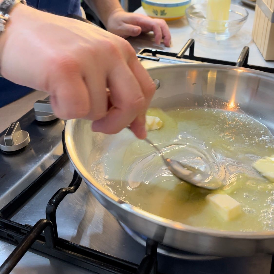 Una persona sta mescolando una pentola di cibo con un cucchiaio