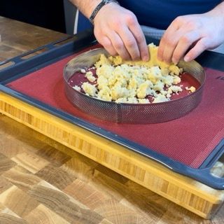 Una persona sta preparando il cibo su un tagliere di legno