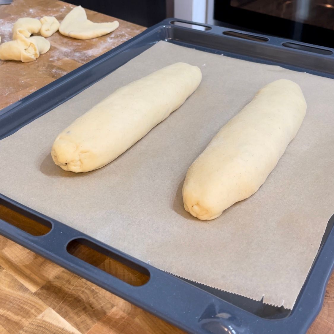Due pagnotte di pasta sono appoggiate su una teglia da forno