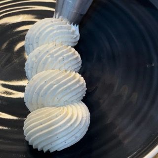 Un primo piano di panna montata su un piatto nero