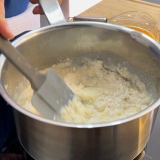 Una persona sta mescolando una pentola di cibo con una spatola
