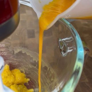 Il succo d'arancia viene versato in una ciotola di vetro