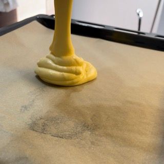 Un liquido giallo viene versato su un pezzo di carta oleata