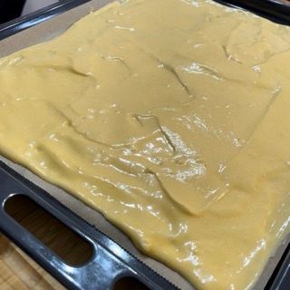 Un vassoio pieno di una sostanza gialla con un manico