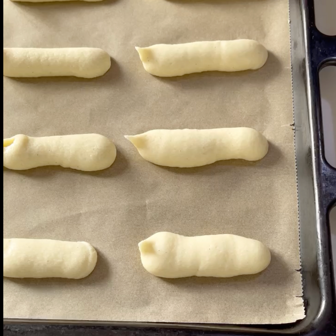 Un vassoio di pasta è appoggiato su un pezzo di carta oleata