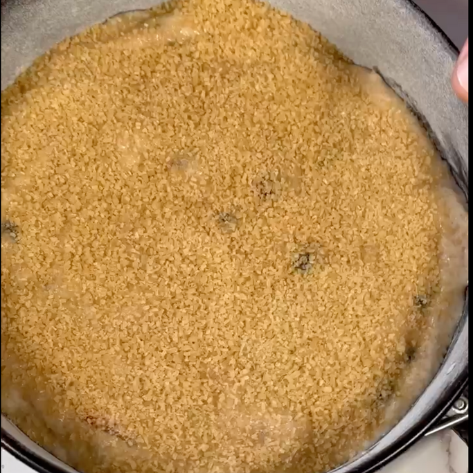 Primo piano di una teglia piena di riso e briciole.