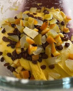 Un primo piano di una ciotola di cibo con uvetta e arance